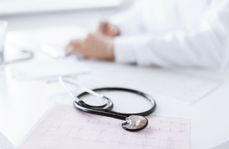 male doctor hands with cardiogram